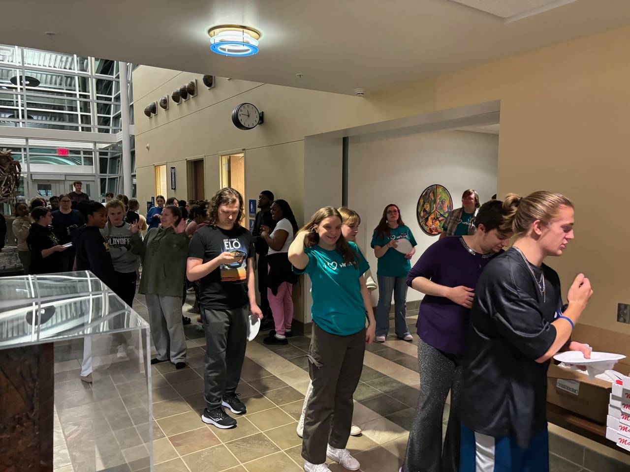 students waiting in line for pizza